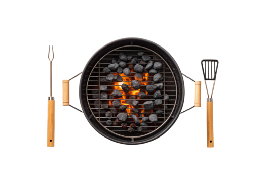 Round black grill with cooking utensils fork and spatula positioned beside burning coals, isolated on a transparent background