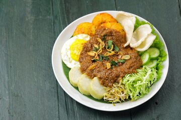 Tahu gimbal is a dish consisting of fried tofu, shredded raw cabbage, rice cake, bean sprouts, eggs, and gimbal mixed with a distinctive peanut sauce because it uses shrimp paste.