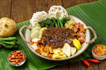 Rujak Cingur is a traditional dish typical of East Java, made from boiled cingur (cow's snout) and mixed with various kinds of fresh fruits, vegetables, lontong,tofu, tempeh