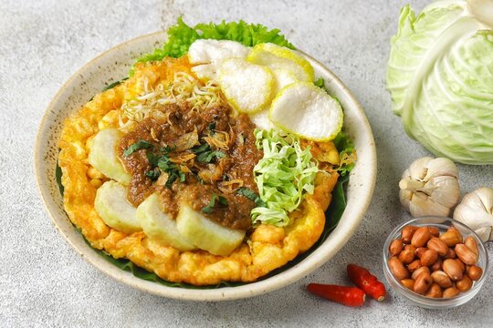 Tahu tek, tahu gunting, tahu telur is a typical Surabaya food consisting of fried tofu, rice cake, fried potatoes, bean sprouts and cucumber, which are drizzled with peanut sauce.
