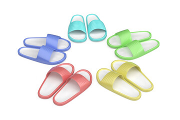 Group of five pairs of rubber slides in different colors on white background