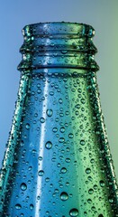 Closeup of a blue glass bottle with water droplets, condensation on surface