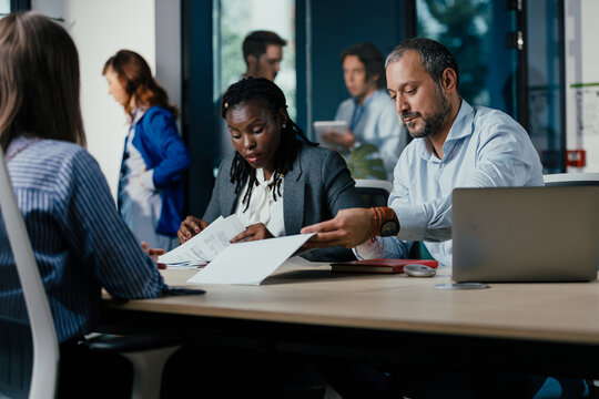 Diverse Business Team Meeting in Open-plan Modern Glass Office