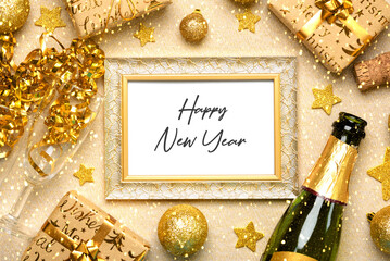 Top view of gold frame with the text Happy New Year, Bottle of champagne,crystal glasses and golden...