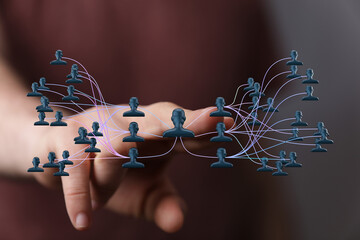 Abstract image of a person touching a digital network diagram representing business connections, social media interactions, and teamwork.