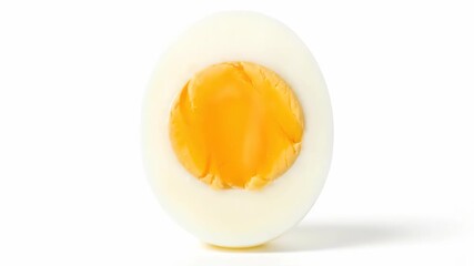 A single hard boiled egg cut in half on a clean white background. - Powered by Adobe
