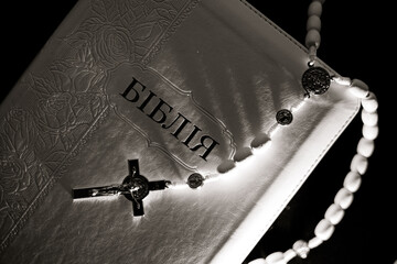 Close-up of rosary and Bible, symbol of faith and prayer