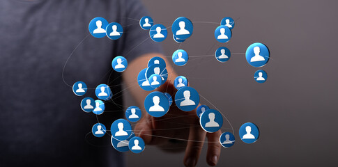 Human hand touching digital network of people, representing connections, communication, and social networking on a modern interface. Ideal for b