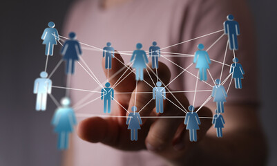 Hand interacting with digital network of people, representing connection, communication, and social networking. Concept of community, global rea