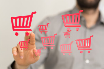 Person interacting with digital shopping cart icons, representing online shopping, e-commerce, and...