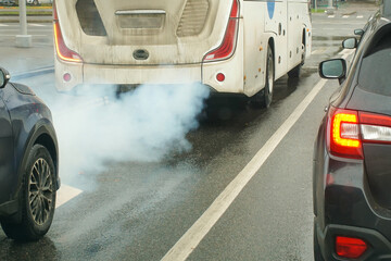 A faulty bus smokes exhaust gases. Pollution of the environment by worn and old vehicles.