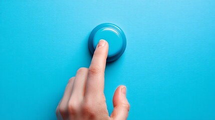 Human Finger Pressing Blue Button on Bright Blue Surface in Close Up