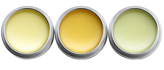Three round metal tins containing different colored balms sit side by side against a white background, showcasing their smooth surfaces and inviting textures, ideal for cosmetic product displays