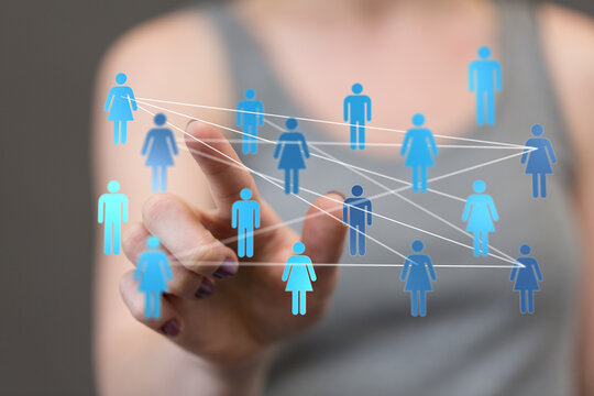 A person's hand interacting with a digital interface of a social network, representing connections, communication, and community.