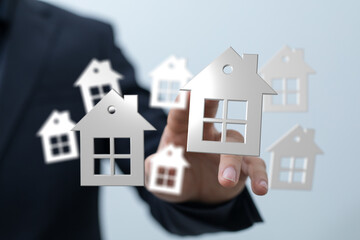 Person holding 3d house icon, real estate concept, home buying, choosing a house, property, investment, building,  buying, housing, and new home