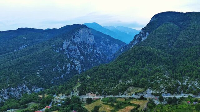 Greek town of Litochoro with small houses against the backdrop of the Mount Olympus and a cloudy sky