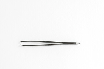 A pair of stainless steel tweezers on a white background. The tweezers are straight and have a smooth finish, suitable for precision tasks.
