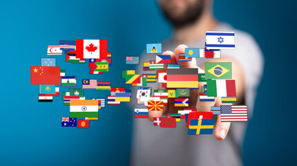 A person's hand reaching towards a collection of various country flags, symbolizing global...