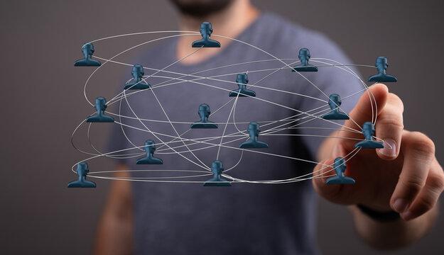 Abstract image showing network concept with people icons and hand touching the network with connection lines.