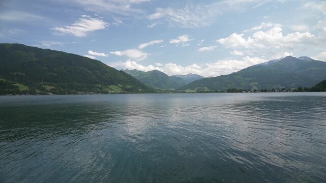 View of Lake Zell with mountainous backdrop on a sunny day, Zell am See, Salzburg, Pinzgau Region, Austria, Europe