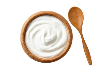 Creamy yogurt in wooden bowl, spoon beside