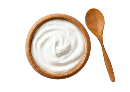 Creamy yogurt in wooden bowl, spoon beside