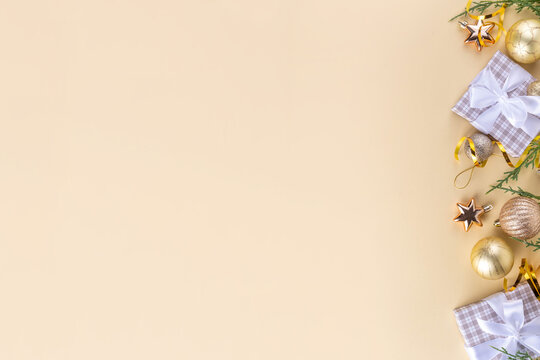 Golden baubles Christmas, New Year background with golden christmas tree twigs and balls, holiday gift boxes, decorations, tablet notepad flat lay on pink background copy space - Powered by Adobe