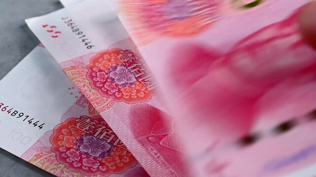 Person counting banknotes 100 yuan or renminbi, video 4k resolution