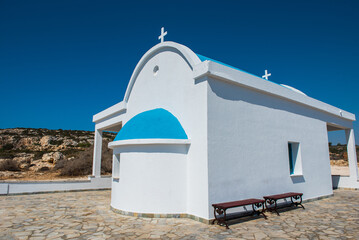 Traditional white chapel with a blue roof on the seaside. Agioi Anargyroi, Cyprus
