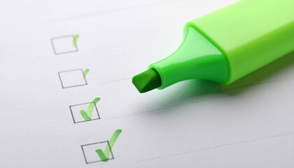 Close-up of a green highlighter marking checkboxes on a paper with a white background and subtle shadow.