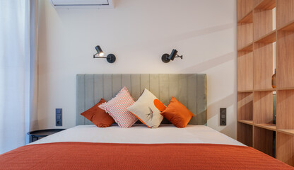 Modern Bedroom with Upholstered Headboard and Decorative Pillows