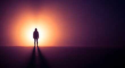 Silhouette of a woman standing in bright light against a purple background