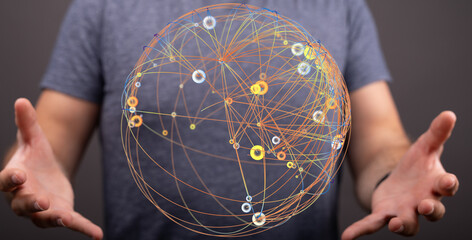 Conceptual image of a person holding a digital network globe, symbolizing global connections, data, and communication. This can repre