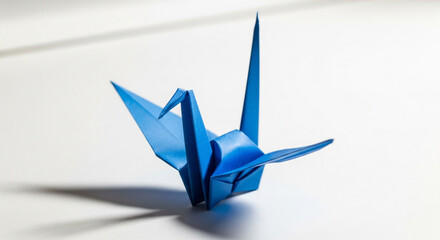 Blue origami crane, isolated on white background