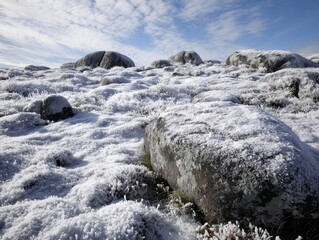 Expansive Winter Landscape Frost-Covered Rocks Field Blue Sky White Clouds Cold Outdoors Nature Scenery Snowy Ground Granite Boulders