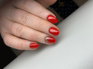 Close-up of female hands with elegant red manicure