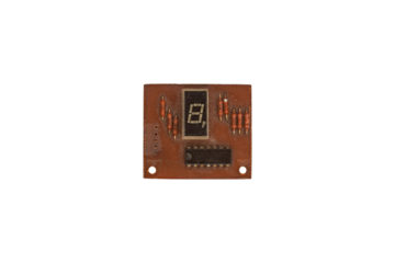 Old brown circuit board with seven segment display and resistors is isolated.