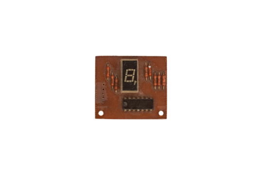 Old brown circuit board with seven segment display and resistors is isolated.
