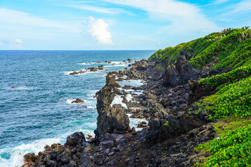 Dramatic black volcanic rock formations on the St. Kitts coast in the Caribbean