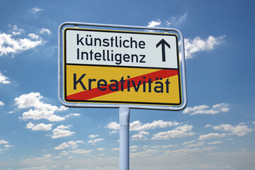 Ortsausgangsschild mit Schriftzug KÜNSTLICHE INTELLIGENZ und KREATIVITÄT