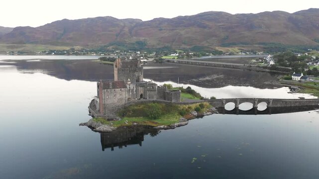 Aerial view of Eilean Donan Castle and lake Loch Duich in Scotland at sunrise