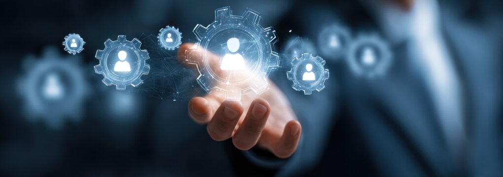 Hand projecting glowing digital user icons within gear shapes.