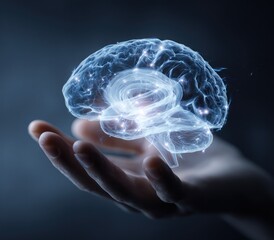 Glowing holographic brain model held in a human hand against dark background.