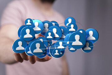 Hand holding network of people icons, representing social connections, business and global...