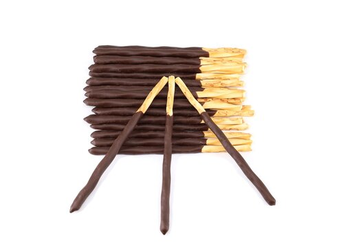 Group of chocolate dipped sticks on white background. top view.
