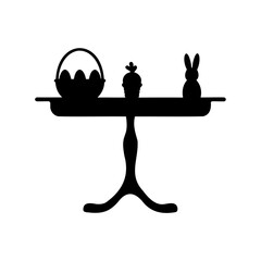 Black silhouette of Easter table arrangement featuring bunny, eggs and cupcake