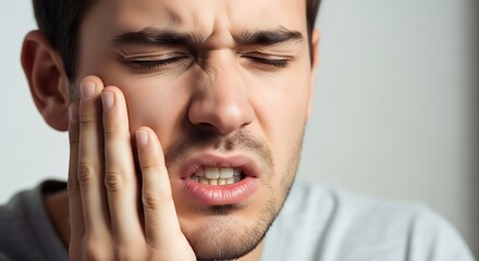 Man Touching Cheek in Dental Pain