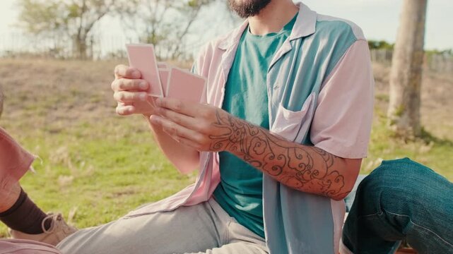 Friends Playing Cards at a Sunny Picnic