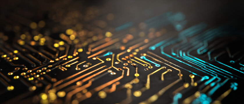 A close up of a circuit board with glowing blue and orange lines