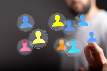 Hand interacting with digital interface showing social network connections and people. Futuristic technology concept with virtual icons, online